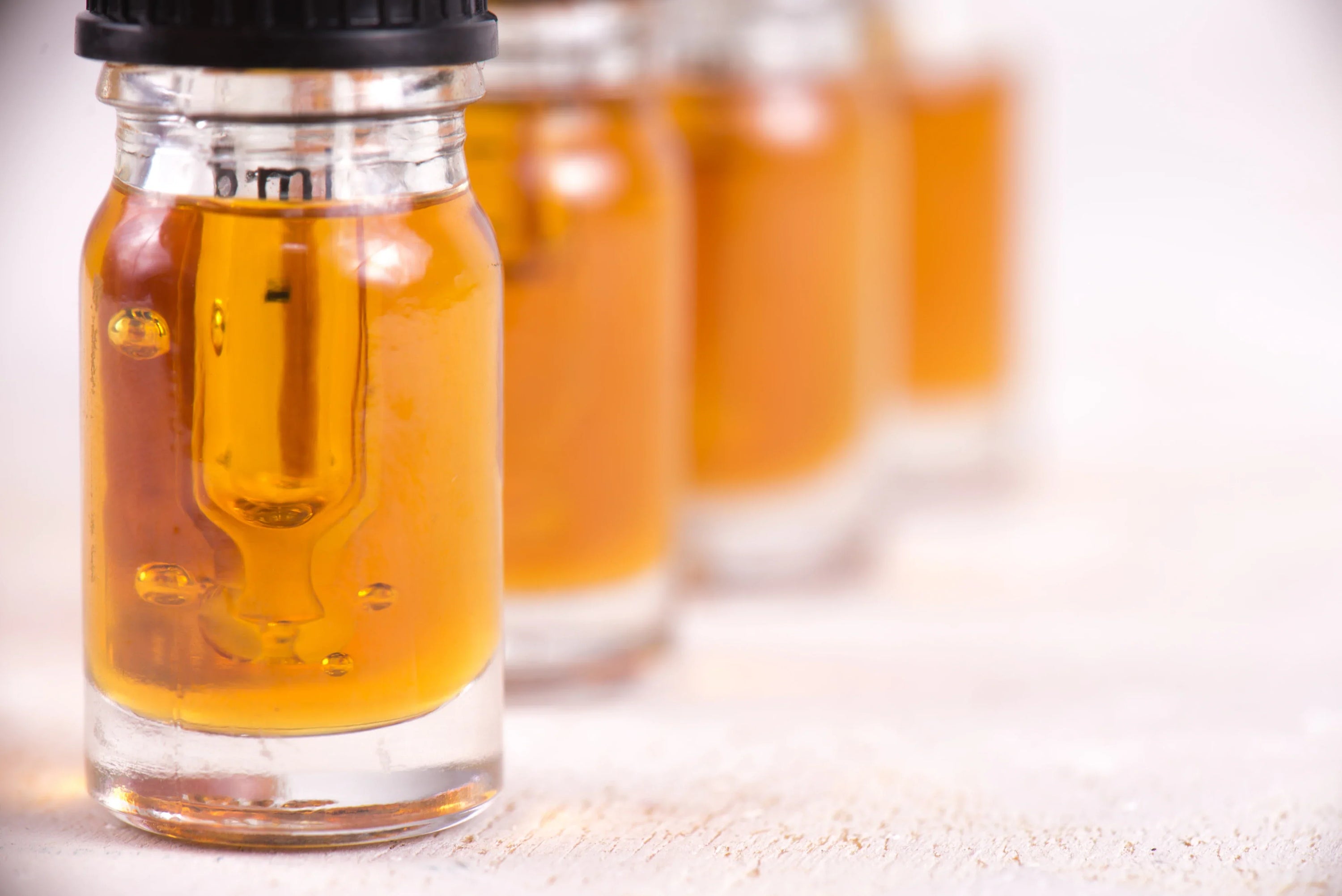 Small glass jars full of oils.